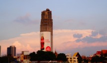 Title: "Abandoned" (Sathorn Unique, Bangkok, Thailand, taken April 8, 2012 Caption: The Sathorn Unique building was intended to become the new defining symbol of Bangkoks waterfront, but after the 1997 economic crisis, it was abandoned mid-construction. It, like other half-finished mega-projects, now stands as cautionary monuments to irresponsible speculation. In the years since, royally-aligned political groups have pointed to ruins like Sathorn Unique as exemplifying the need to follow Buddhist principles of restraint and non-desire.
