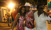 Title: samba Caption: This photo was taken at a 2012 Carnaval celebration in Rio de Janeiro Brazil. It is a local gathering in the Tijuca neighborhood. Members of two different samba groups are shown in the picture. They proudly display their samba school colors. Music, friendship and dance unite even the strongest competitors.  