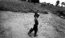 Title: Lillian comes for a visit. Padibe East, Northern Uganda, 2010. Caption: Lillian finally moved out of Padibe Internally Displaced Person's Camp with her grandmother in January 2009. Although not often spoken about in International media that concentrates exclusively on Joseph Kony, the Ugandan Government's policy of forced displacement to squalid makeshift camps were responsible for most of the deaths in the 2-decade conflict in northern Uganda. A 2005 study, for example, found that there were over 1000 excess deaths per week as a result of the terrible conditions in the camps.
