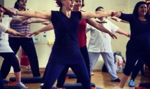 Title: Fragments from one of the many women-only gyms in Istanbul - 1 Caption: Fitness class, composed of young lower class Muslim women, performing for female audience in a homosocial space. This small group is composed of those who agreed their bodies to be photographed, despite the fact that they would not accept to perform to a mixed (men and women) audience. Photo of Ataturk and the Turkish national anthem is hanging on the wall behind the performers.
