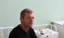Title: Iulian Caption: In over 100 interviews with patients, no one spoke with more love about their family than Iulian, a 42 year-old XDR-tuberculosis patient living in a mountaintop Romanian TB sanatorium. His family was unable to survive without the money he earned as a day laborer. He was tortured by his inability to care for them. When he was healthier, he would interrupt treatment and return to work. Over the course of two years, I watched this young man weaken and die of a curable disease because he was poor. No one should have to choose between their familys survival and their own. Iulian chose theirs. After his death, I visited his wife and 7 year-old daughter and gave them this picture.  
