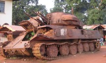 Title: Final Resting Place Caption: Sitting beside the road, this tank is a daily reminder of the war that devastated Sierra Leone for over a decade. Local residents tell the story of how the tank came to be in Segbwema due to a break down during fierce fighting that destroyed most of the town. They speak with pride of the heroes who bravely attacked the tank in an attempt to save their families from capture. Recovery has been slow as the people struggle to rebuild their homes and communities without the support of an adequate national infrastructure, but the spirit of the people is strong. This tank is a symbolic representation of the stories that will be passed to the next generation and become the legends of the future.