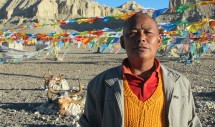Title: Thoeling and its caretaker, October 2011 Caption: Although this photo is of a man, the photo is more about a place that once was. The man is Tibetan and caretaker of the Thoeling monastery in Zanda, Tibet. When this photo was taken, this man and a monk were walking the sunset kora around the once impressive perimeter of the monastery. Founded in the 11th century it was once one of the most important monasteries in Tibet and today only a few structures are left in tact. The rocks in the background are remainders of what was left by the Chinese Red Guards after the cultural revolution 1958- 1974 that destroyed much of Tibetan history and culture. Today Zanda is a Chinese army base and the Tibetans live segregated in their own community.