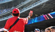Title: Get 'Em Here! Caption: A hot day in Dodger Stadium, a seller calls out his frozen lemonade to over warm park-goers as the Dodgers take the field.  