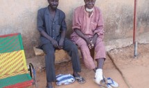 Title: Father - Son Reunion in Niamey, Niger Caption: After receiving his father's permission, Koche "Yagi" Dan Jima (seated on the left) left Togone, his home village, 30 years ago as a teen to establish himself as a small-scale dry goods trader in Niamey, Niger's capital city. Yagi has assiduously maintained ties with Togone over three decades through visits on special occasions such as naming ceremonies and funerals and by sending remittances to his father, Bizo Dan Jima. This photo depicts one of Bizo's annual trips to Niamey to check up on his son.  