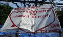 May 7, 2010. Farmers display a tarpaulin pleading with Philippine President Noynoy or “P-noy” for comprehensive land reform. Urban poor neighborhood associations regularly create encampments outside Department of Agrarian Reform (DAR) building gates to protest the Urban Development and Housing Act (UDHA), which was passed in 1992 and is, for the majority of the urban poor and its advocates, a largely ineffective housing policy premised on failed land redistribution policies. Photo courtesy Faith R Kares