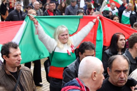 A Protester wearing the colors of the Bulgarian flag.