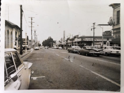 cars line an open main-street style avenue