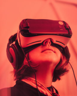 Close up of a woman with a VR headset on, her face tilted skward.