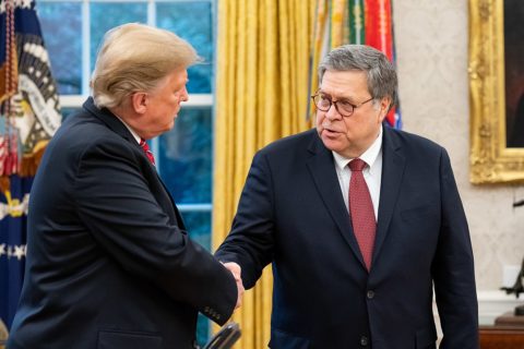 President Trump and Attorney General William Barr stand in the Oval Office, shaking hands.