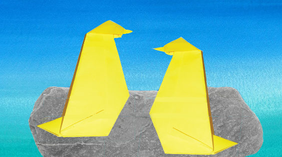 Two origami penguins sit on a rock, against a watercolor-painted sky.