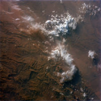 This image, taken on August 1965, by astronauts of the Gemini V mission, illustrates the snowed peaks of the Atlas Mountains, rising on the rigged reddish colorful lands of Morocco.