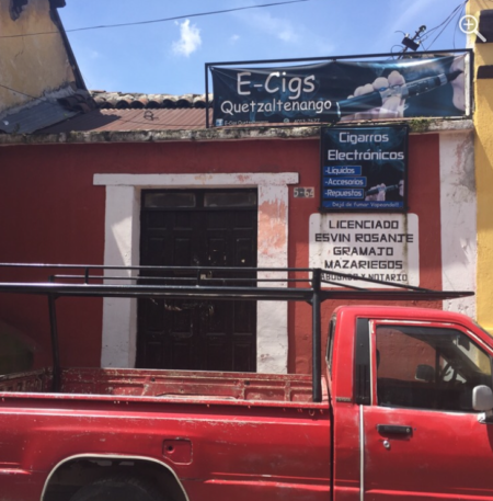 Several signs on a red-painted building.