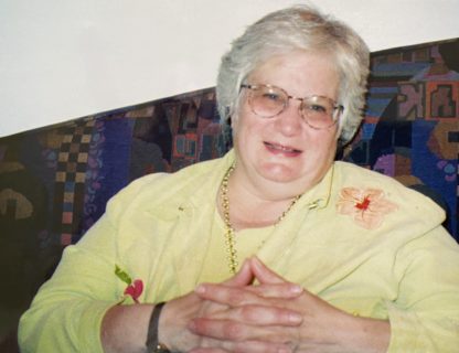 Photograph of a woman sitting on a couch