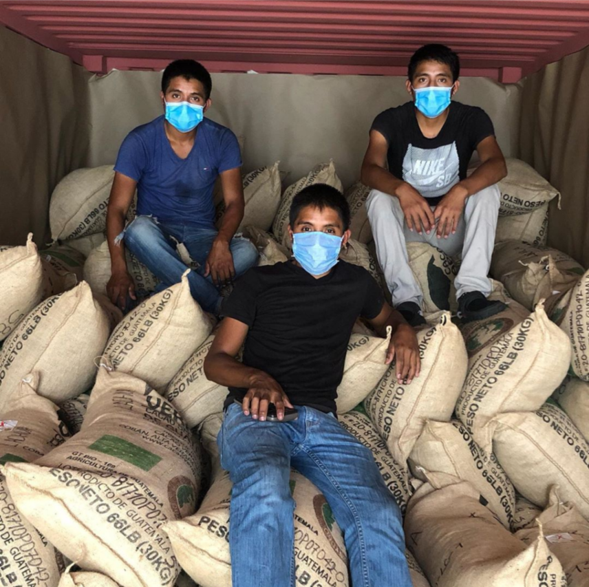 Photograph of people sitting on bags