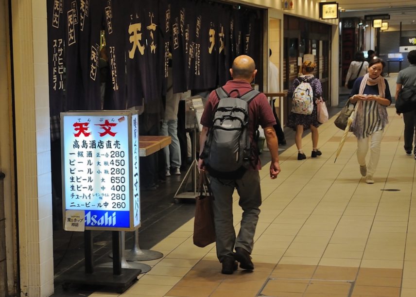 Photograph of people walking in a corridor.