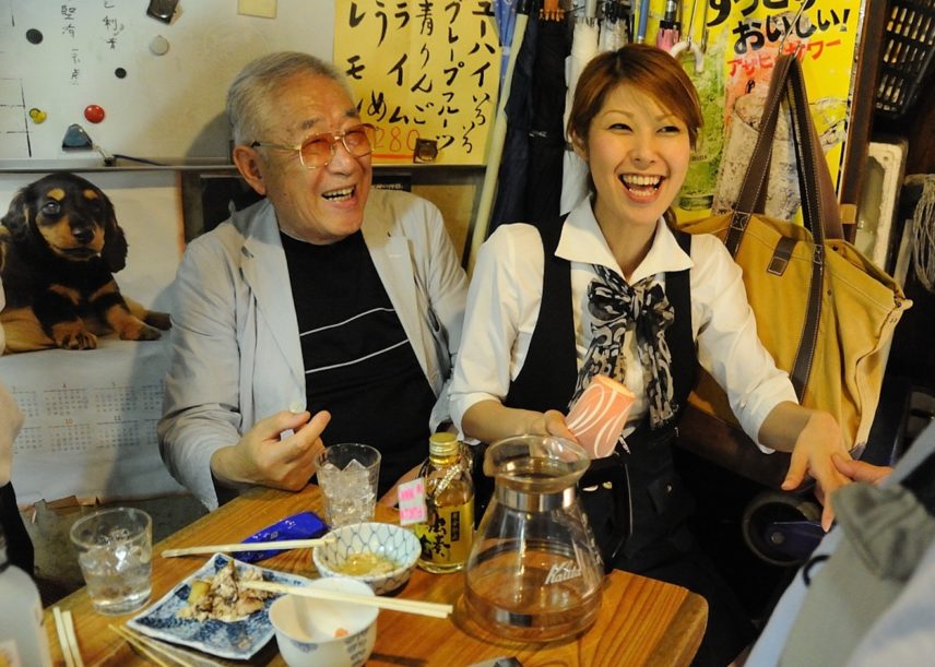 Photograph of two people sitting at a table.