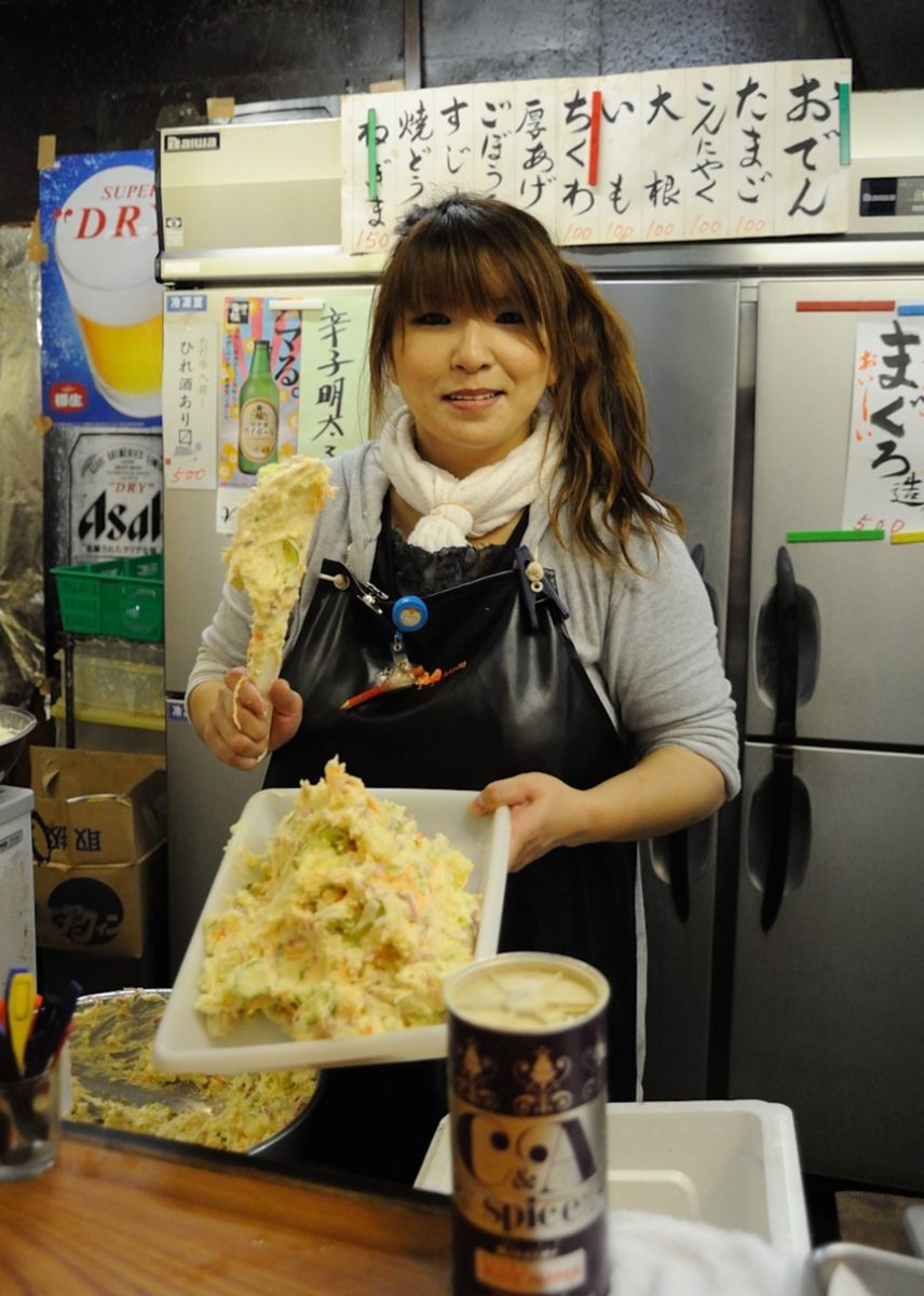 Photograph of a woman holding a tray of food