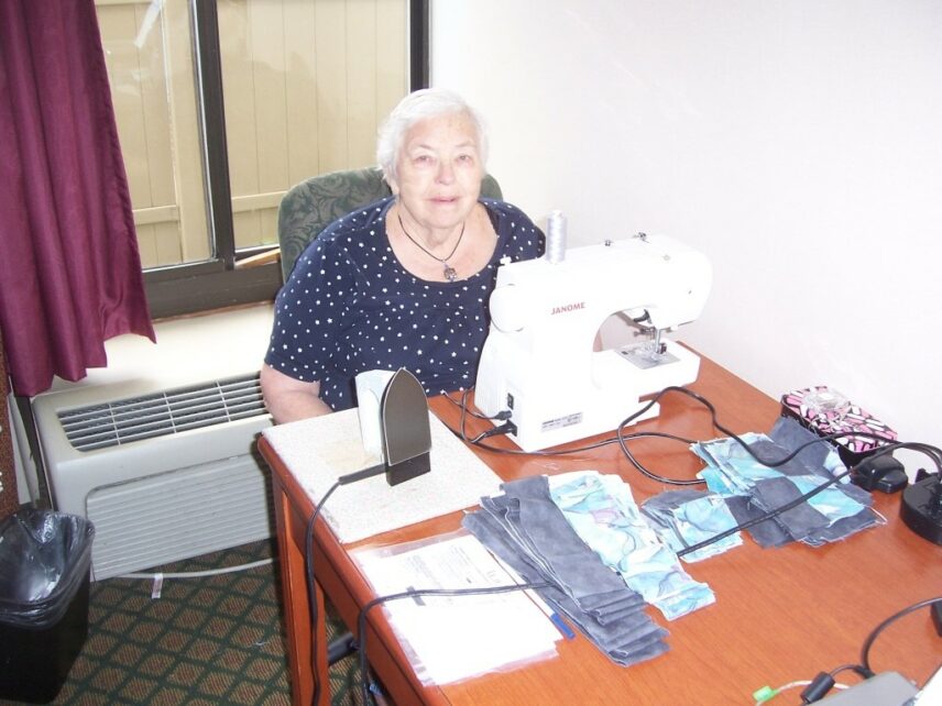 Photograph of a woman sitting indoors at a table