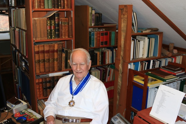 Photograph of a man sitting indoors