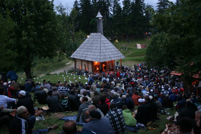 A photograph shows an outdoor gathering