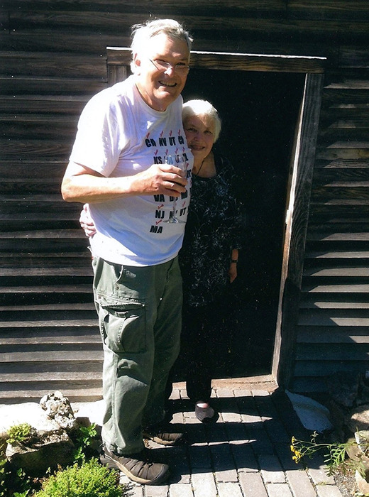 Man and woman standing in front of a small doorway