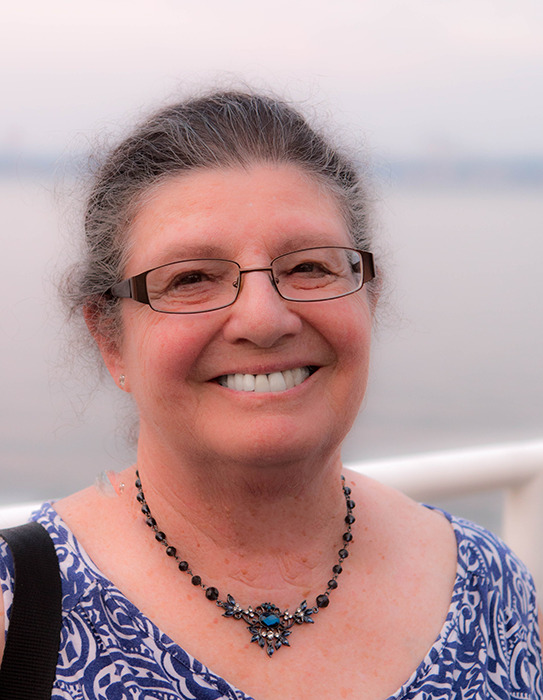 Photograph of a woman outdoors in front of a railing