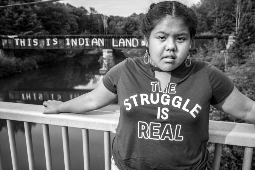 Black and white photograph of a girl standing outdoors