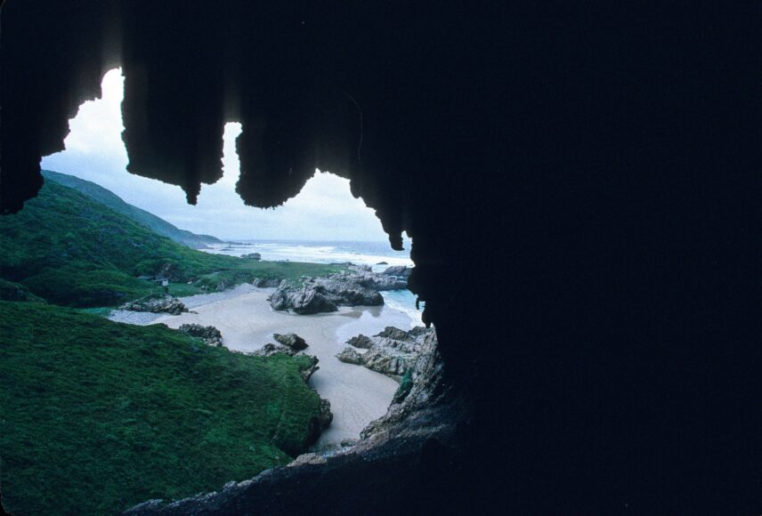 Photograph of a coastline taken from inside a cave