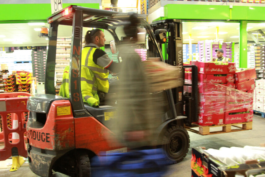 Photograph of a forklift carrying a pallet