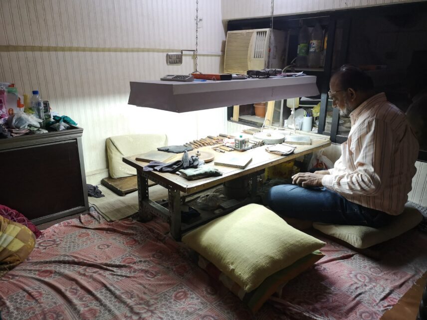 Photograph of a person sitting at a low table