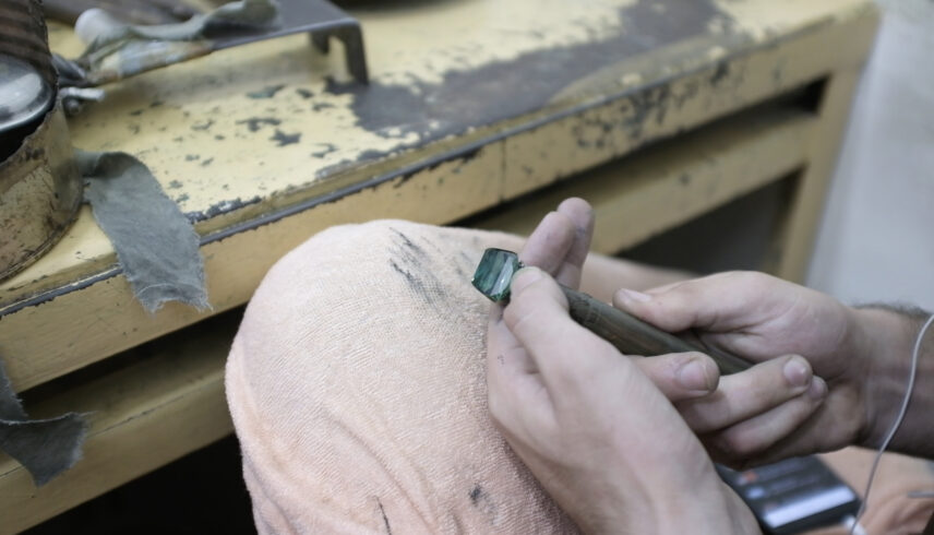 Photograph of hands working on a gem