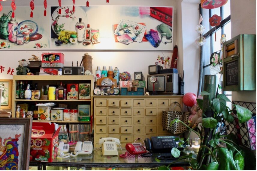 Photograph of the interior corner of a room filled with colorful objects.