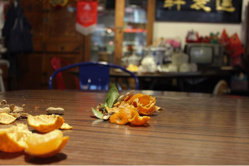 Photograph of orange peels and peanut shells on a table