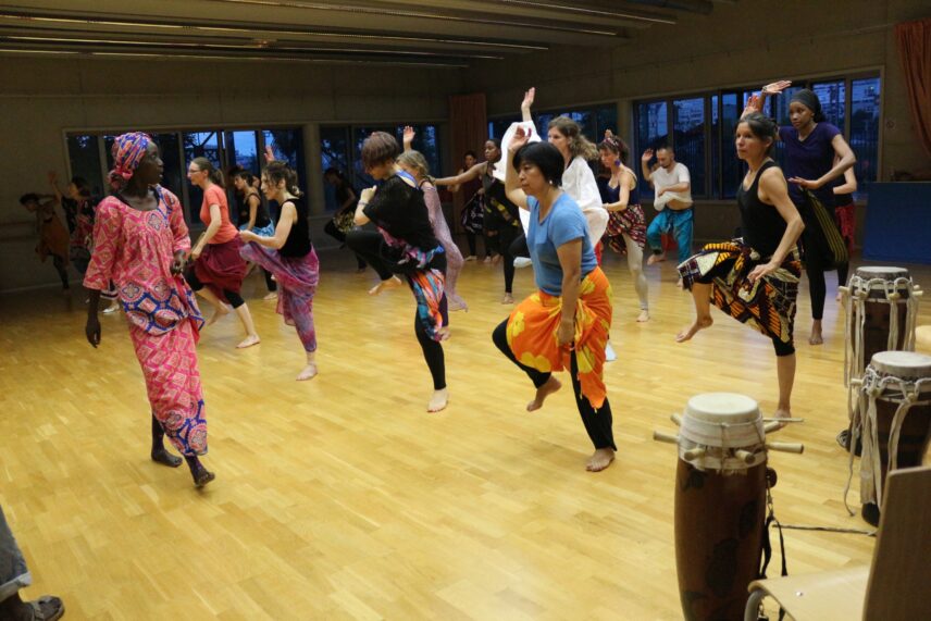 Photograph of a group of people in the middle of a dance class