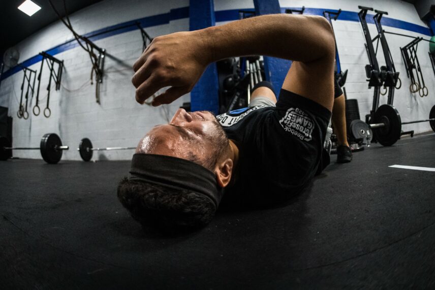 Photograph of a person lying on the floor in a gym