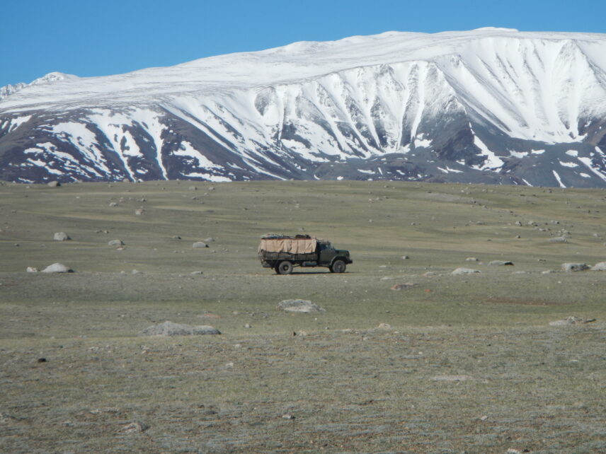 Photograph of a truck driving across a field