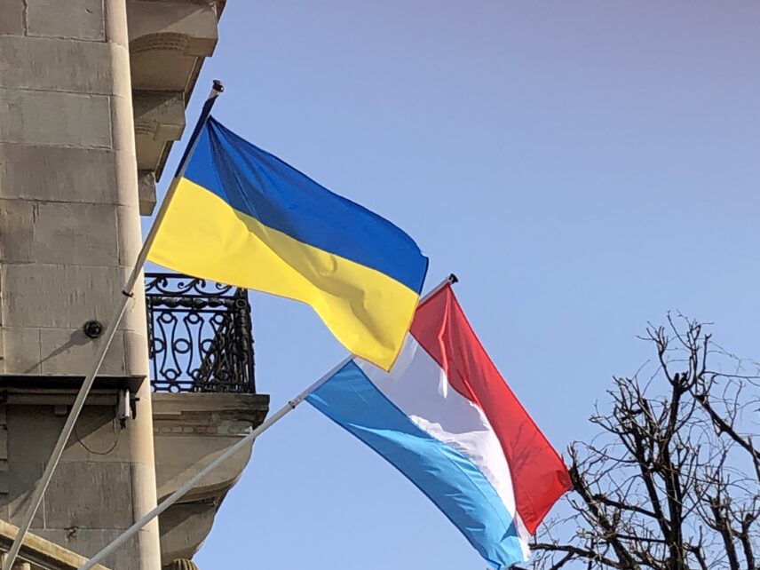 Photograph of two flags affixed to a building