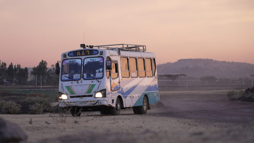 Photograph of a bus on a dirt road