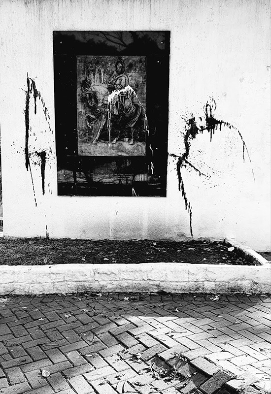 Black and white photograph of an image on a wall