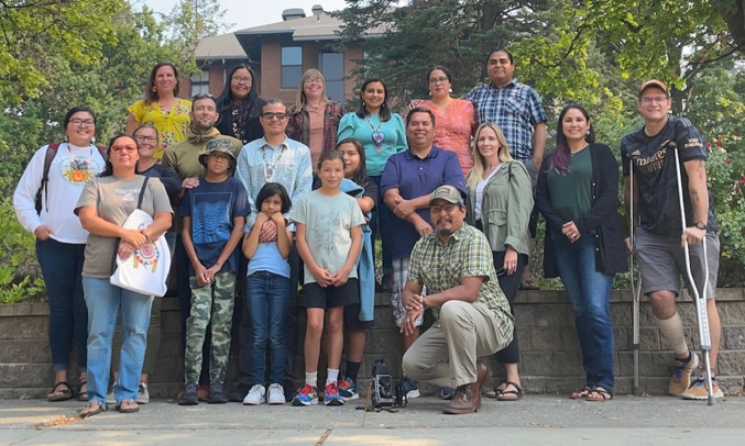 Photograph of a group of people posing outdoors