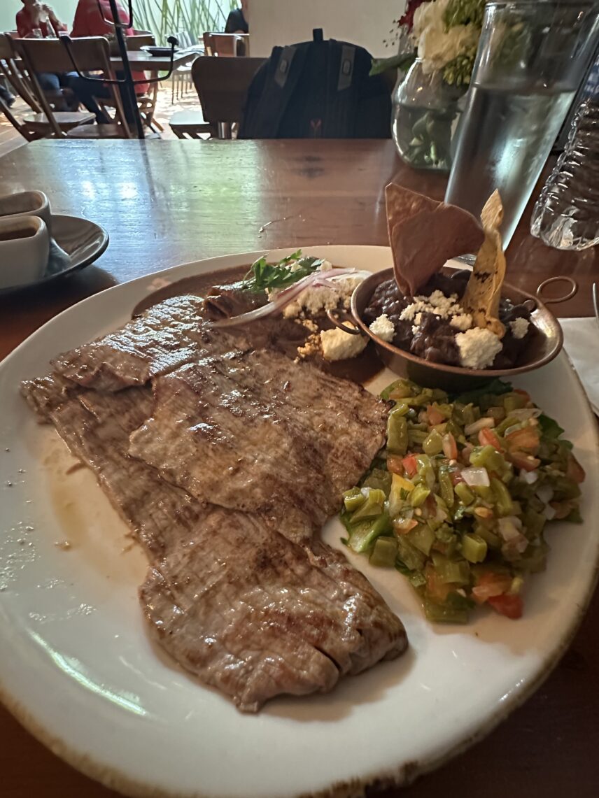 This dish of tasajo, or Oaxacan-style beef, is a typical meat preparation from the region. This version, from an upscale restaurant in Oaxaca City’s center, came with two large pieces of this thinly sliced beef, a pico de gallo salsa with nopales (or cactus), a side of meatless mole enchiladas, a large serving of mashed black beans, and tortillas to make yourself small tacos on the side.