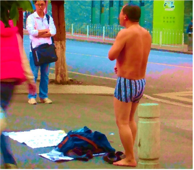 A photograph of a young man panhandling