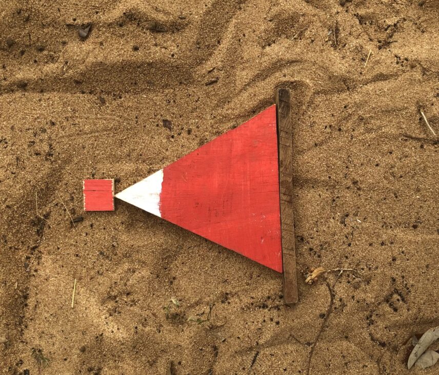 Figure 2 - How to indicate the presence of a suspected landmine. Picture taken at a HALO Trust training site in Sri Lanka.
