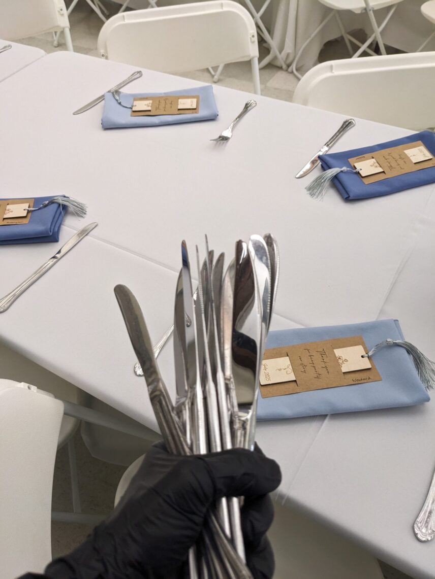 Knives in the left hand, placed an inch above the table edge with the right: a well-practiced movement.