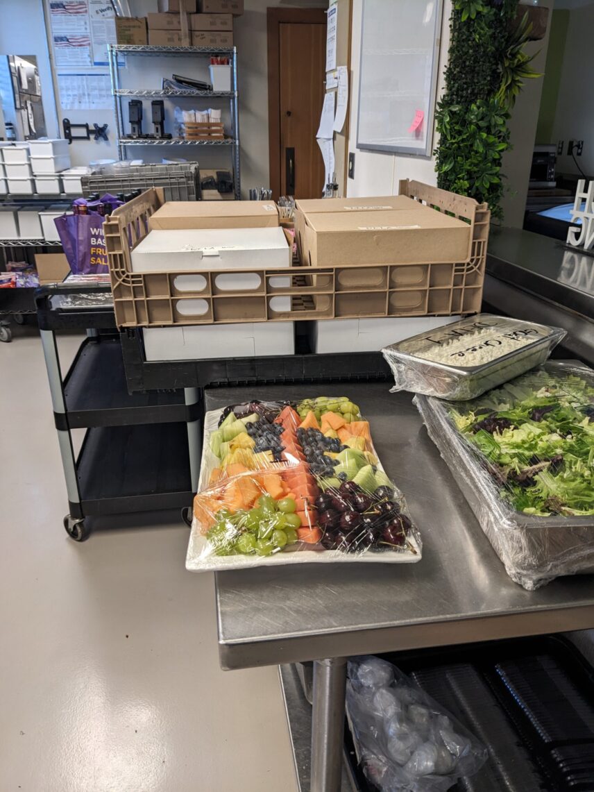 Sorting supplies and finding fridge space in a packed kitchen.