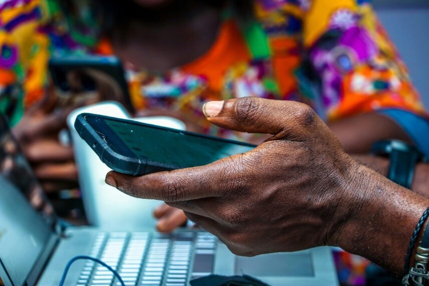 An image of a hand, holding a digital device representing queer Nigerian activism on decolonisation through social media