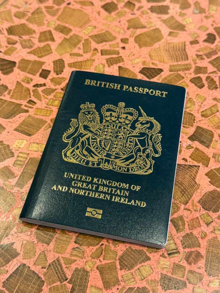 A British passport on a red table