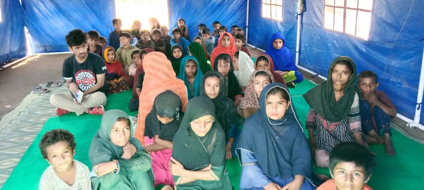 The author, during fieldwork, interviewed a female teacher inside a temporary learning center, capturing the realities of flood-affected communities and the challenges of teaching in crisis settings.