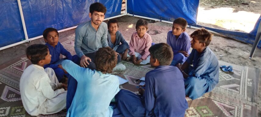 Focus group discussion with children in a temporary classroom during the Pakistan Super Floods of 2022, part of a thesis on education in crisis.
